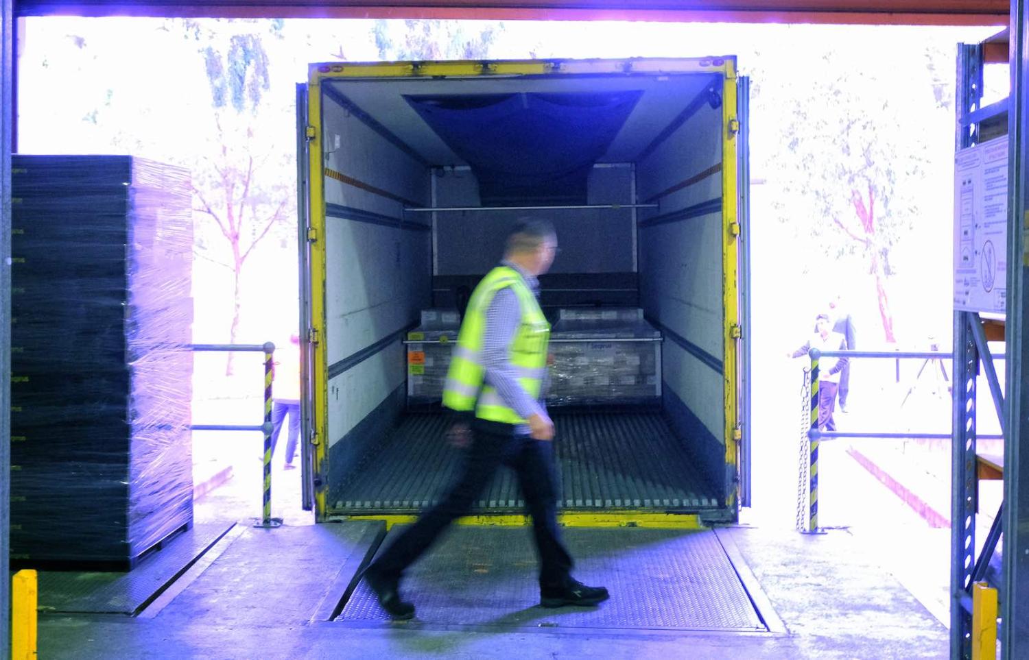 Workers at CSL loading the first batch of Australian-produced AstraZeneca Covid-19 vaccine for distribution, Melbourne, 24 March 2021 (Luis Ascui/Getty Images)